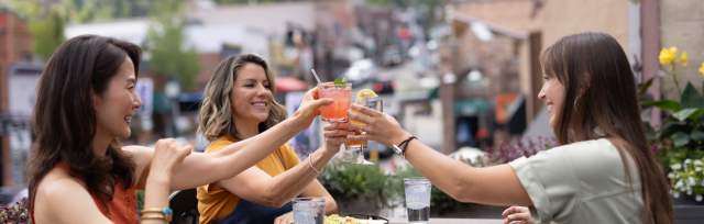 three women dining outside in summer