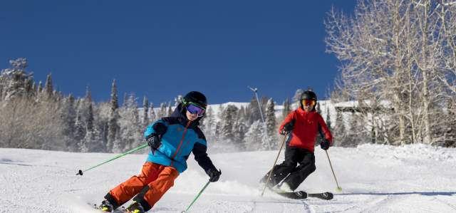 Family skiing on sunny day at Deer Valley Resort
