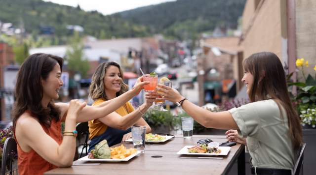 three women dining outside in summer