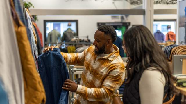 A man and Woman are shopping for a jacket