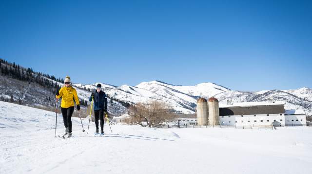 Man and Women Nordic Skiing at Park City Nordic Center with a clear sky