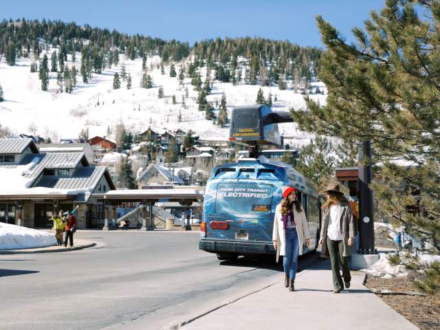 Girls walking past electric bus at Old Town transit Center