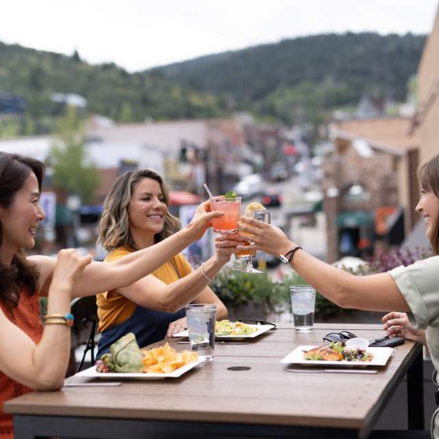 three women dining outside in summer