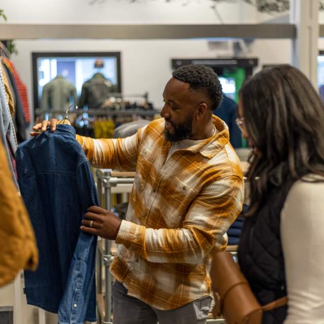 A man and Woman are shopping for a jacket