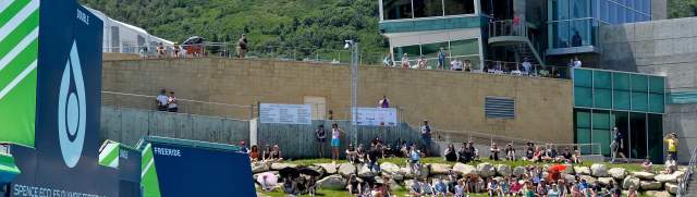 Skiers and snowboarders jump into a pool during a summer Flying Aces aerials show in front of a large crowd at the Utah Olympic Park in Park City, UT