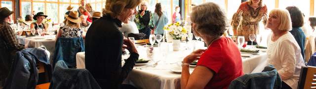 People sitting and conversing at tables at the 100 Mile Meal event in Park City, UT
