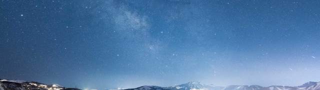 Stars above a brightly lit Park City, UT