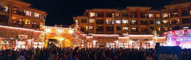 Concert goers listen to a performance at night at Canyons Village in Park City Mountain