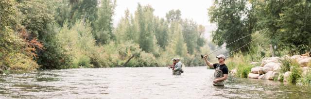 man in foreground fly fishing
