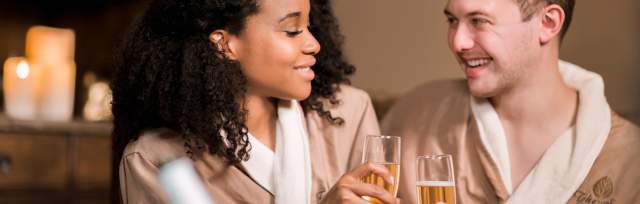 A couple cheers champagne in spa