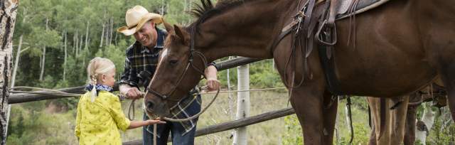Girl Prepares to Ride a Horse
