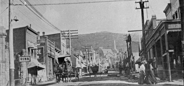 A black and white photo of Historic Main Street in Park City, UT before it was paved with horses and carts