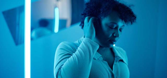 A woman massage her head in a sensory room in Park City, UT