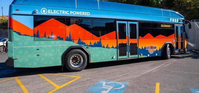 An electric bus stops in front of a handicap parking spot in Park City, UT
