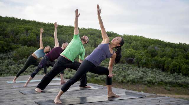 Group doing yoga outdoors at Blue Sky Ranch