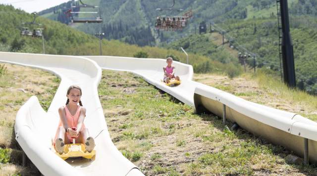 Two people enjoying the alpine slide at park city mountain