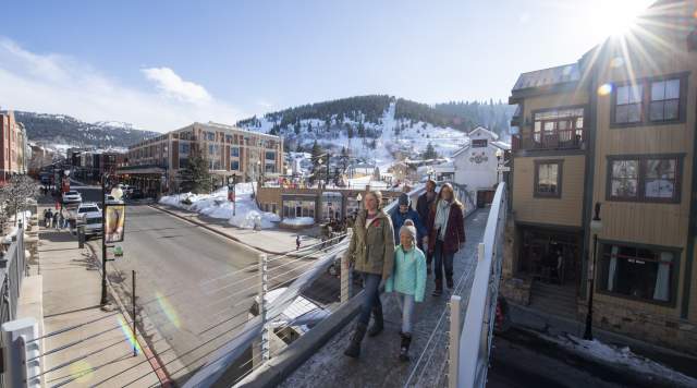 Family walking across bridge on Lower Main Street