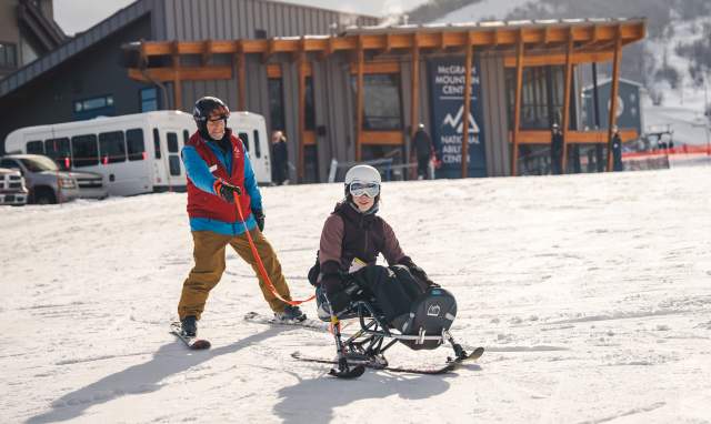 A guide and adaptive athlete on a ski run at Park City Mountain in Park City, UT