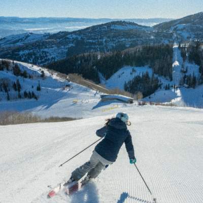 Skier Skiing Down a Groomed Trail
