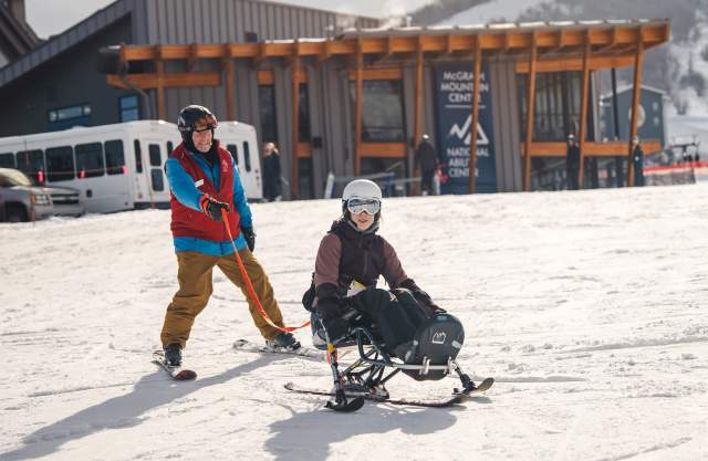 A guide and adaptive athlete on a ski run at Park City Mountain in Park City, UT