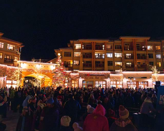 Concert goers listen to a performance at night at Canyons Village in Park City Mountain
