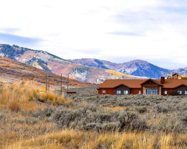 View of The Lodge at the National Ability Center in front of fall mountain in Park City, UT