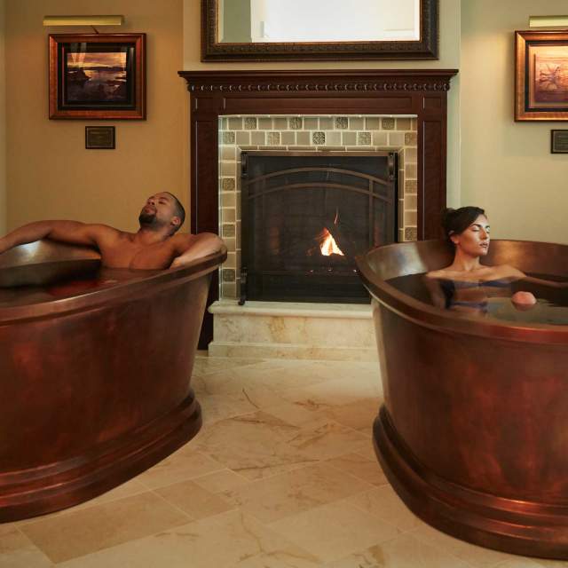 Two people soak in copper tubs in the Montage Hotel in Park City, UT