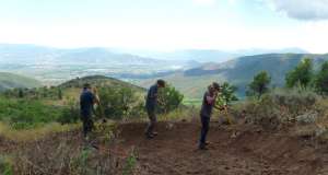 three people working on a trail