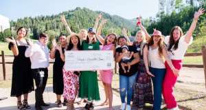 group holding a large check