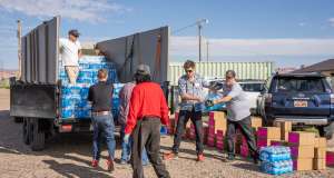 People loading a truck with water