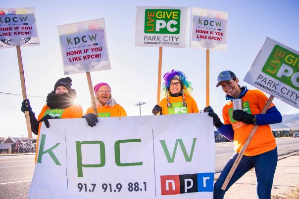 Group of People Holding Live PC Give PC signs