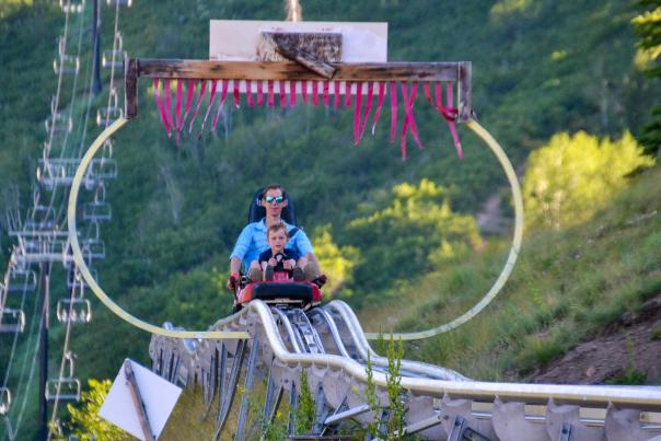 Father and Son ride down the alpine coaster at Park City Mountain