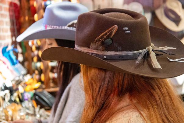Two women wear cowboy hats with charms and accessories at Kemosabe in Park City, UT