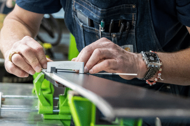 A technician tunes the edge of a ski at Rennstall in Park City, UT