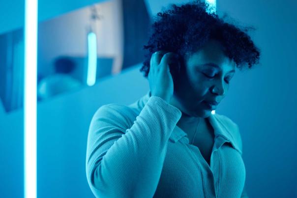 A woman massage her head in a sensory room in Park City, UT