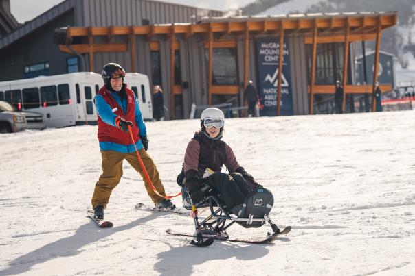 A guide and adaptive athlete on a ski run at Park City Mountain in Park City, UT