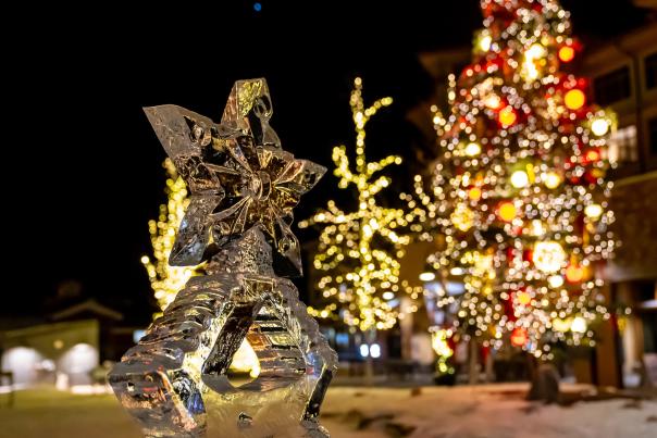 An ice sculpture sits in front of a lit tree at Canyons Village in Park City, UT