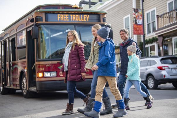 Family walking across Main Street in front of Trolley