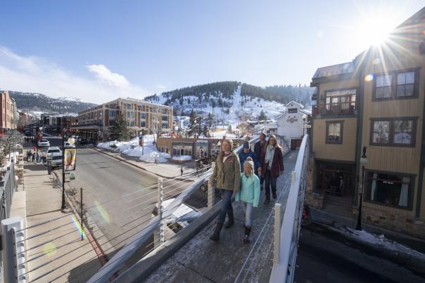 Family walking across bridge on Lower Main Street