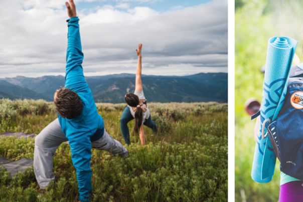 Man and woman in a yoga pose in a grassy field.