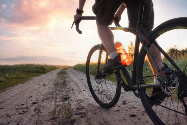 Low angle view of a gravel riding pedaling a bike on a gravel road near Park City, UT