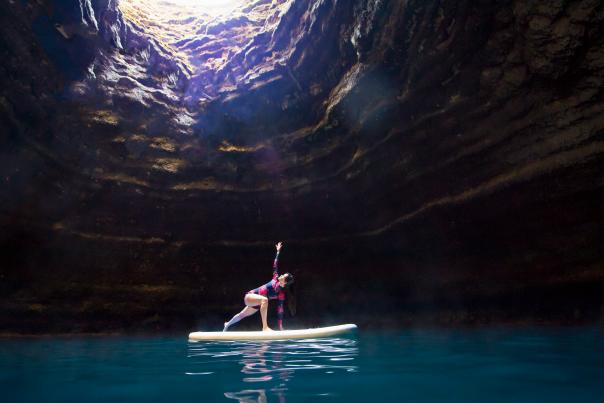 Woman in yoga pose on paddle board