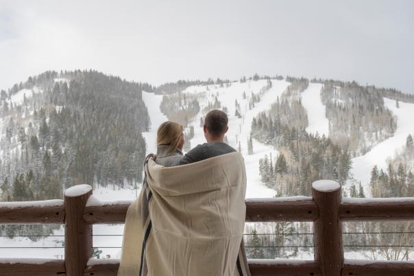Couple wrapped in a blanket on Flagstaff deck at Stein Eriksen Lodge