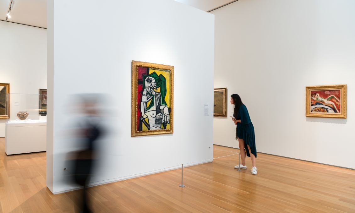 Gallery at North Carolina Museum of Art; a work by Pablo Picasso hangs on the wall as two visitors walk nearby
