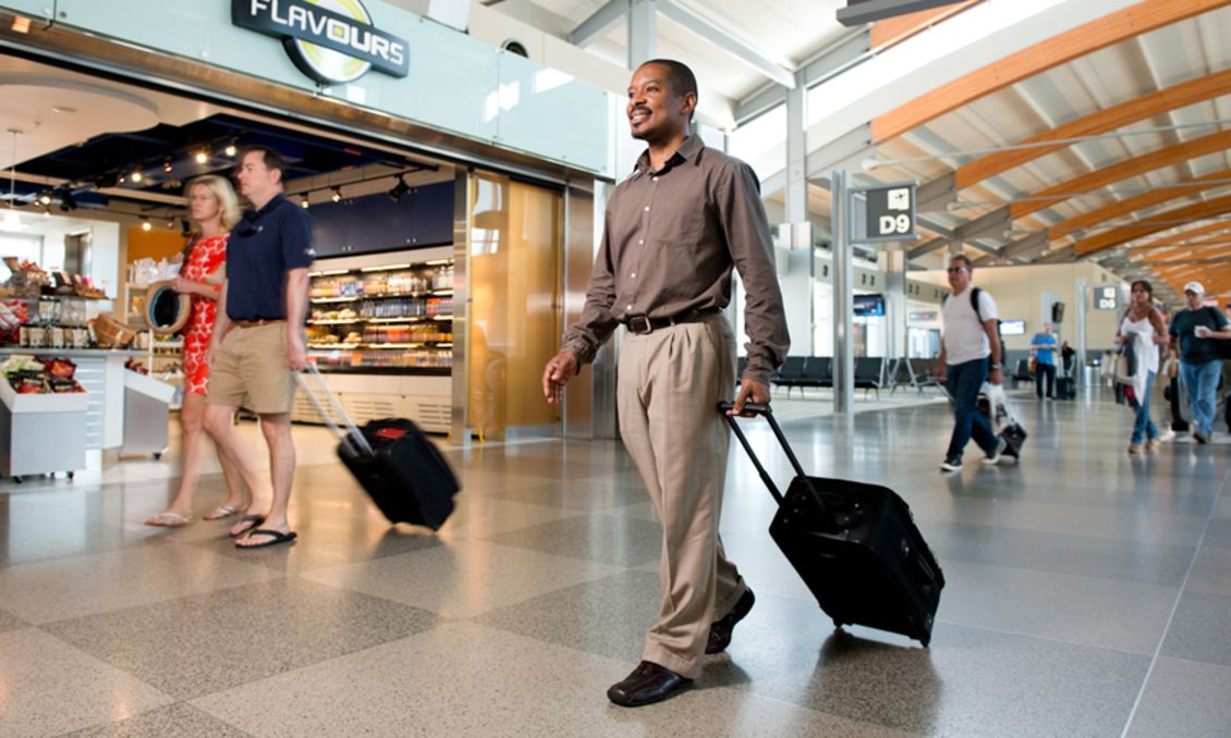 Travelers walking through RDU International Airport with luggage