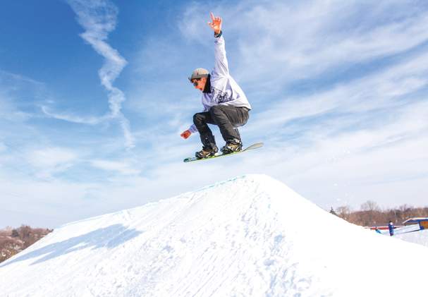 Showboarder on a jump at Snow Park at Alpine Hills