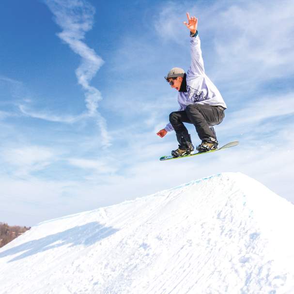 Showboarder on a jump at Snow Park at Alpine Hills