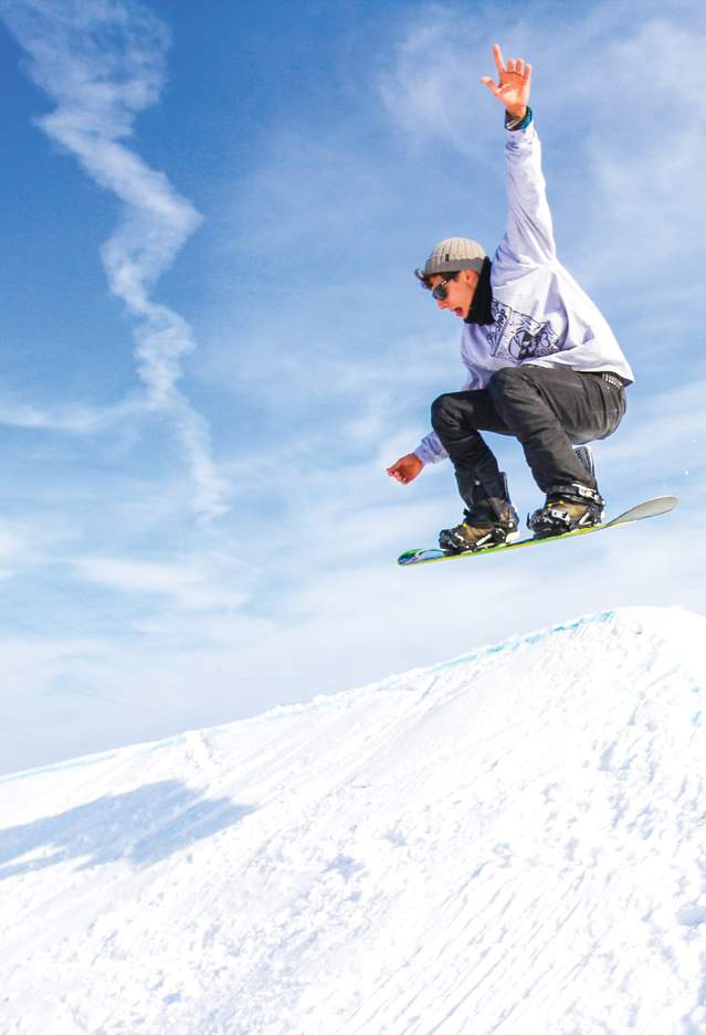 Showboarder on a jump at Snow Park at Alpine Hills