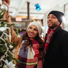 Couple at Stroll on State next to tree