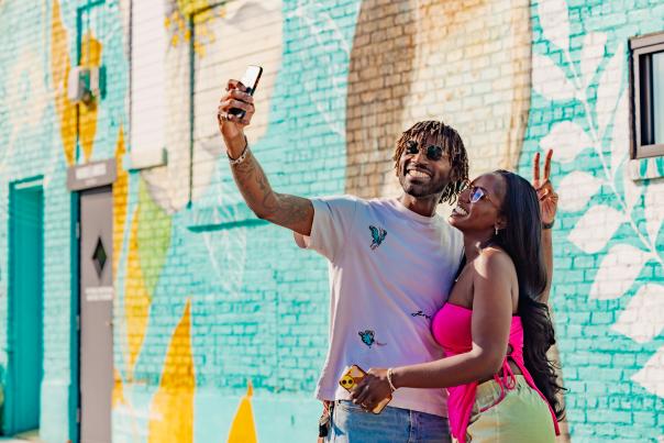 couple taking photo in front of mirror